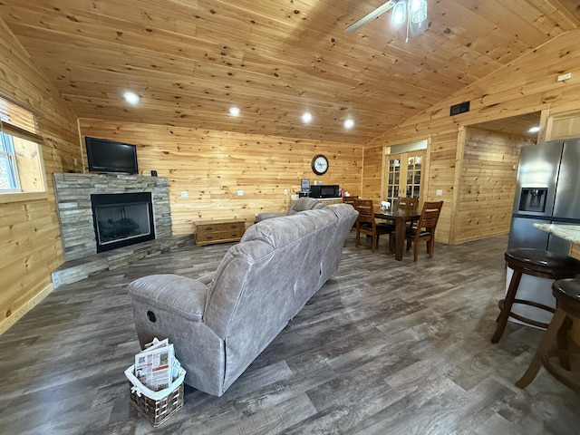 living room with wood walls, wood ceiling, and vaulted ceiling