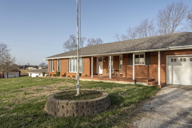 ranch-style home with driveway, a front lawn, covered porch, a garage, and brick siding