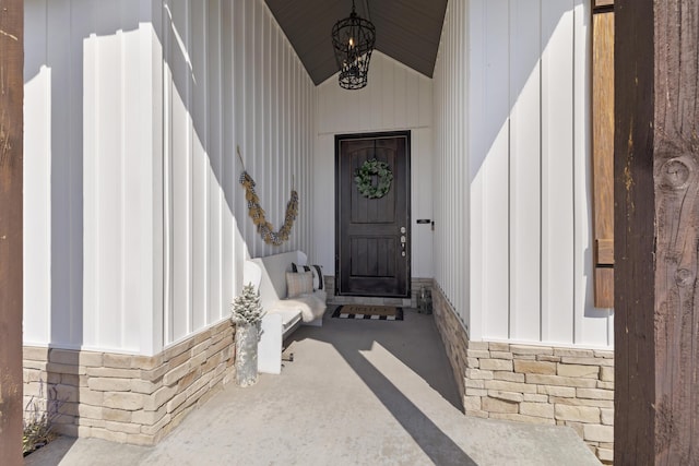 property entrance featuring stone siding and board and batten siding