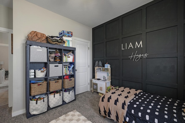 carpeted bedroom featuring a decorative wall