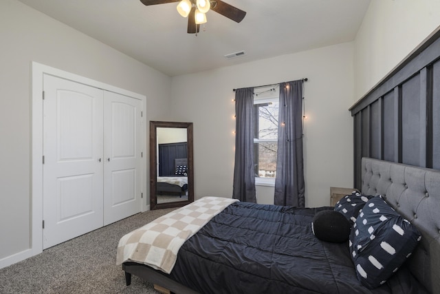 carpeted bedroom featuring a closet, visible vents, and a ceiling fan