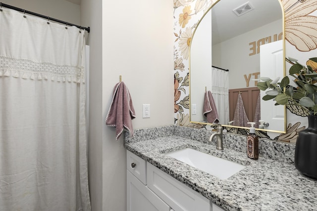 bathroom with visible vents and vanity