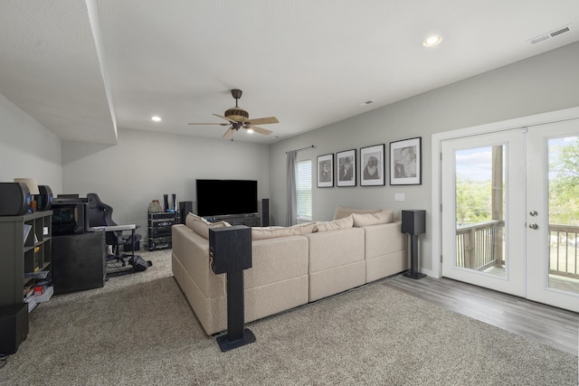 living room with plenty of natural light, french doors, visible vents, and wood finished floors