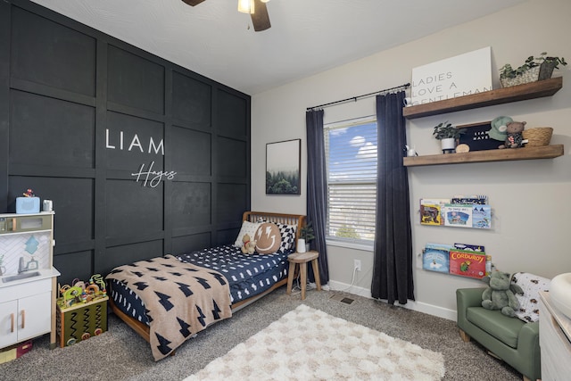 carpeted bedroom with a ceiling fan and baseboards