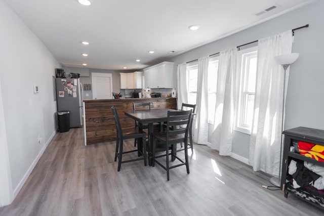 dining room with recessed lighting, visible vents, baseboards, and wood finished floors