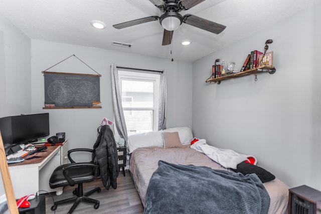 bedroom with a ceiling fan, recessed lighting, wood finished floors, and visible vents