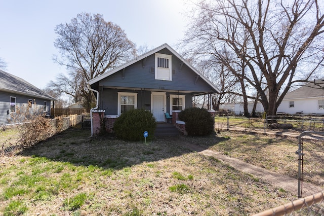 bungalow featuring a porch, fence, brick siding, and central AC