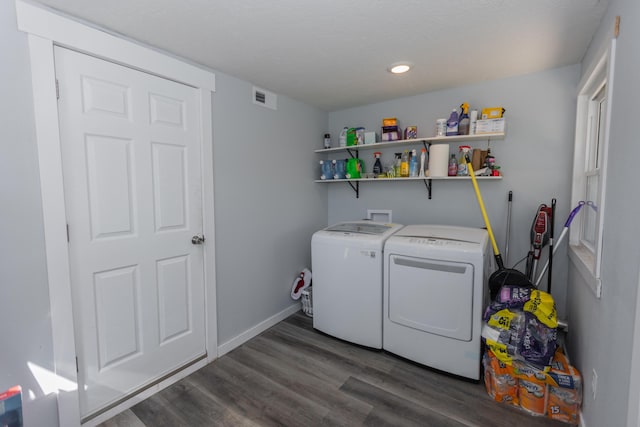 laundry area featuring visible vents, baseboards, dark wood finished floors, laundry area, and separate washer and dryer