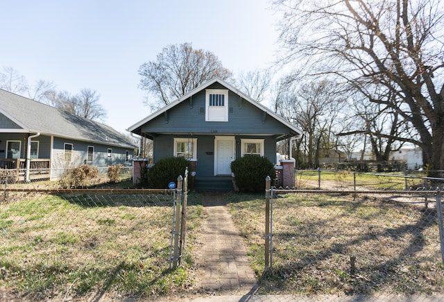 bungalow with a fenced front yard, covered porch, and a gate