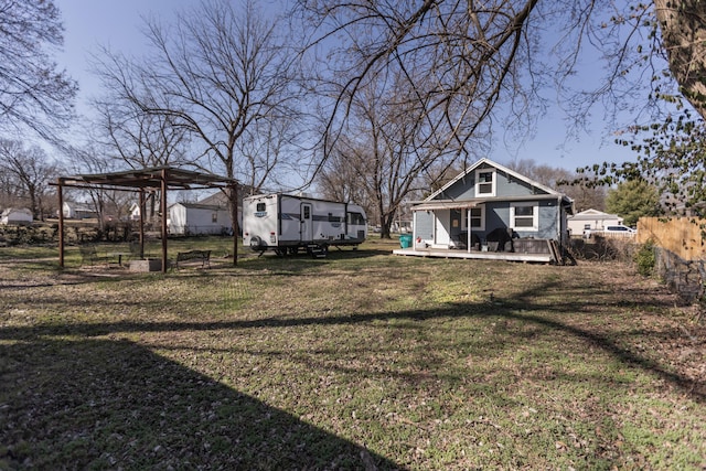 view of yard featuring a wooden deck and a carport