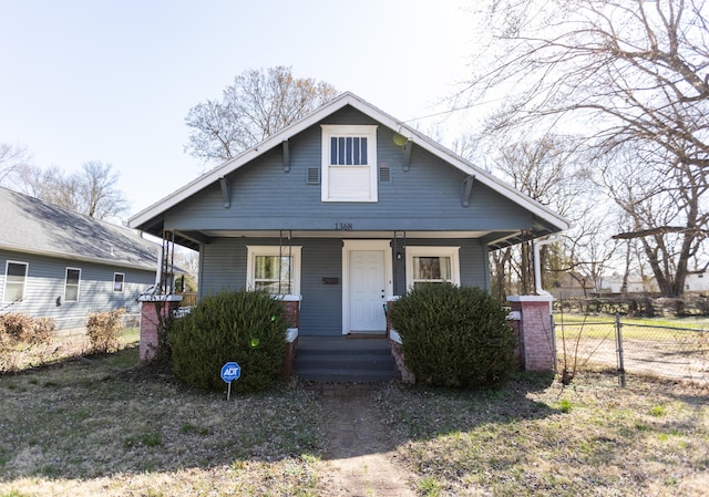 bungalow-style house with a porch and fence