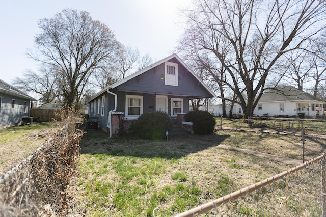 bungalow-style home featuring brick siding, covered porch, and fence