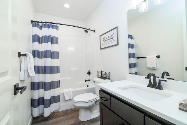 bathroom with toilet, recessed lighting, shower / tub combo, wood finished floors, and vanity