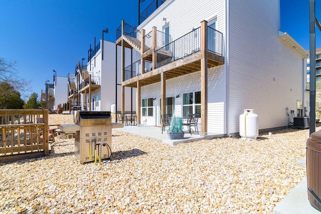 rear view of house with a patio and cooling unit