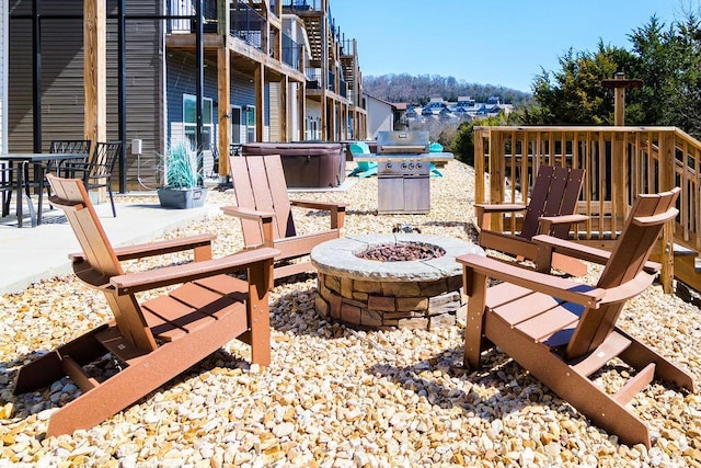 view of patio featuring a grill and a fire pit