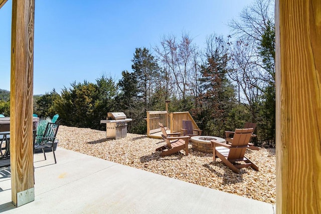 view of patio with a fire pit and a grill