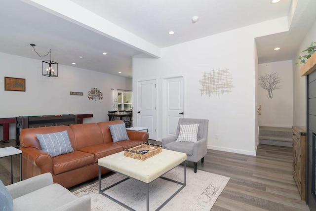 living area featuring recessed lighting, baseboards, and light wood-style floors