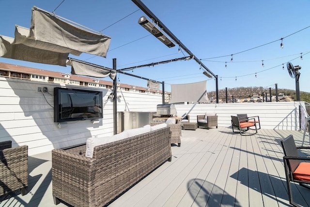 wooden deck with an outdoor living space