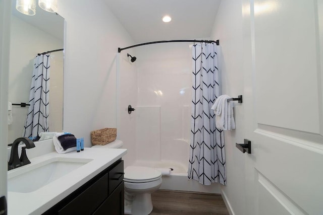 bathroom with vanity, wood finished floors, recessed lighting, toilet, and shower / tub combo with curtain