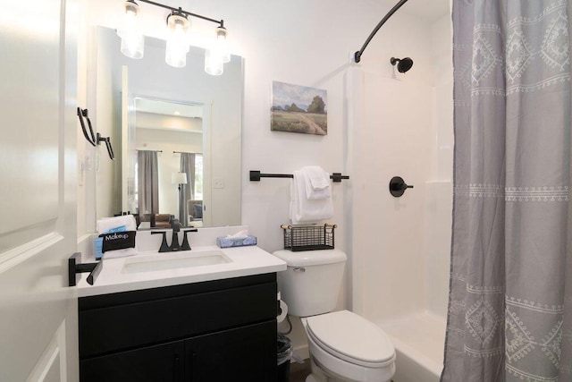 bathroom featuring a stall shower, toilet, and vanity