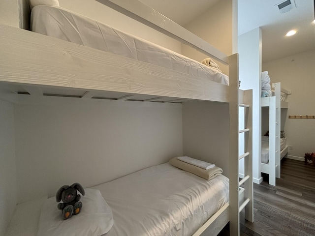 bedroom with dark wood finished floors, recessed lighting, and visible vents