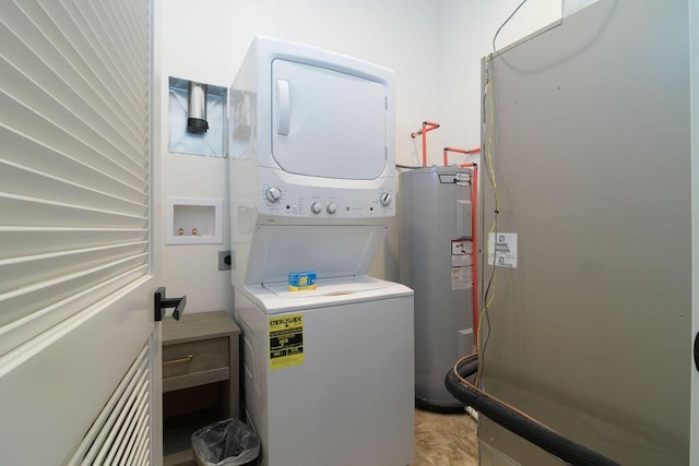 laundry room featuring stacked washer / drying machine, laundry area, and water heater