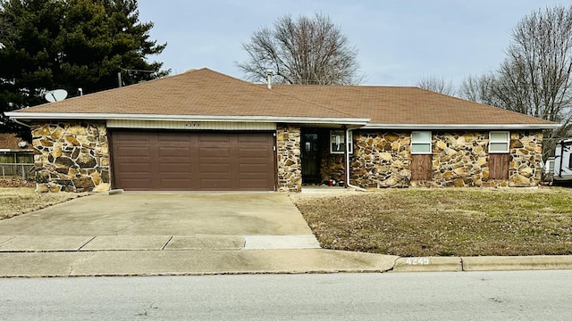 single story home with a garage, stone siding, and driveway