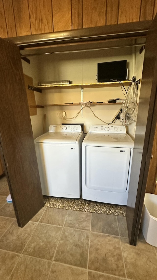 clothes washing area with tile patterned flooring and washer and clothes dryer