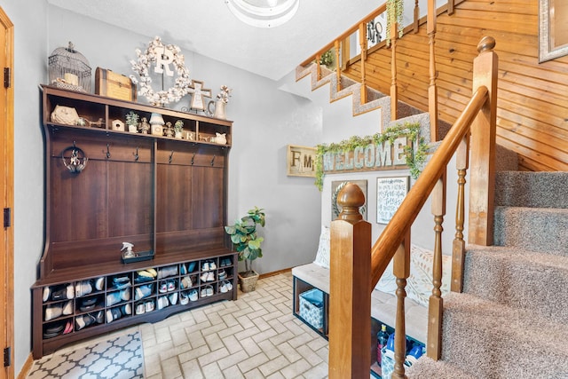 mudroom with baseboards and brick floor