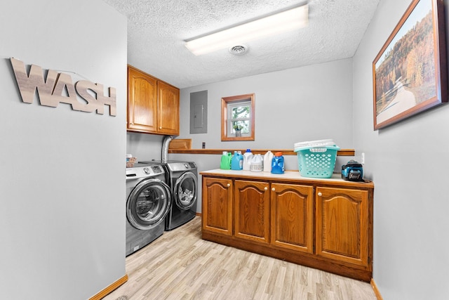 washroom with visible vents, electric panel, separate washer and dryer, cabinet space, and light wood-style floors