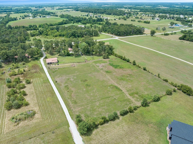 birds eye view of property with a rural view