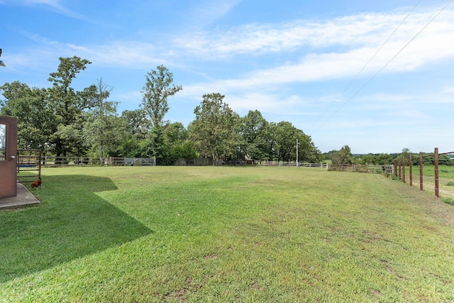 view of yard with a rural view and fence