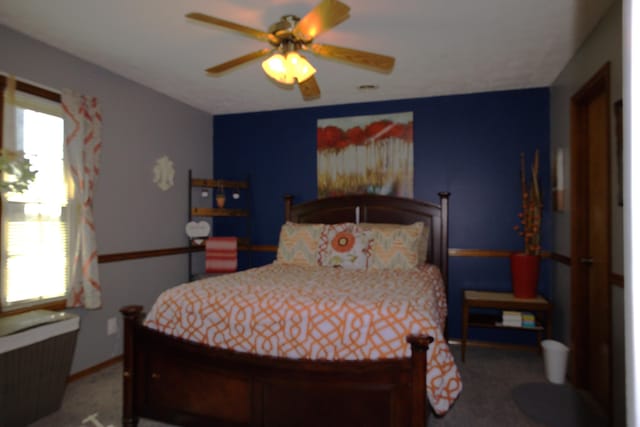 carpeted bedroom featuring multiple windows and radiator heating unit