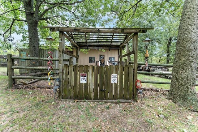 view of outbuilding featuring a gate and fence