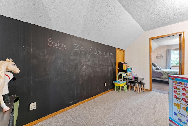 rec room with baseboards, a textured ceiling, carpet, and vaulted ceiling