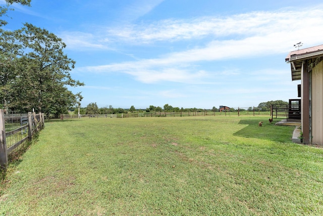 view of yard featuring a rural view and fence