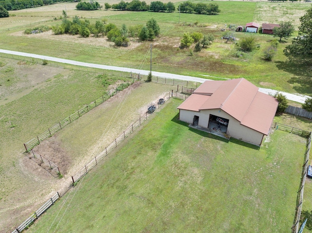 birds eye view of property with a rural view