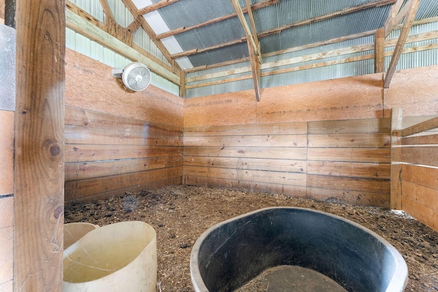 bathroom featuring vaulted ceiling and a tub to relax in