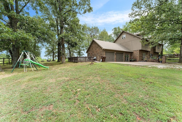 view of yard with concrete driveway, fence, and a garage