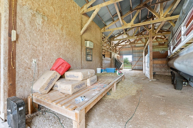 view of patio / terrace with an outbuilding, an exterior structure, and an AC wall unit