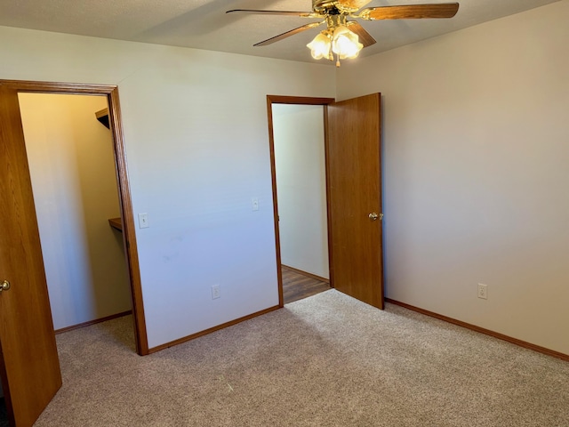 unfurnished bedroom featuring ceiling fan, baseboards, and carpet floors