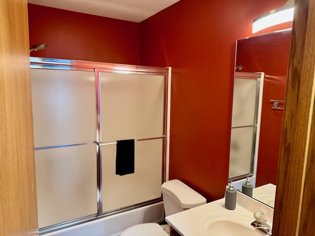 full bathroom featuring vanity, toilet, and enclosed tub / shower combo