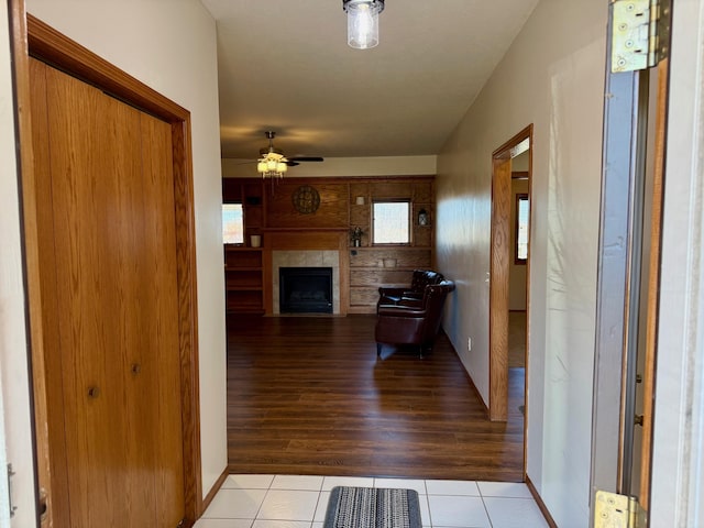 hallway with light tile patterned floors and baseboards