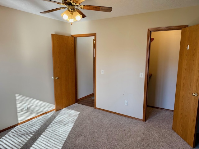 carpeted bedroom featuring baseboards, a textured ceiling, and ceiling fan