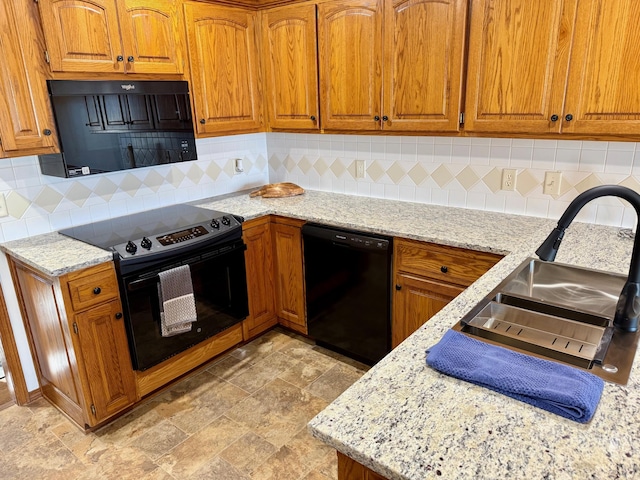 kitchen featuring electric range, light stone countertops, black dishwasher, and brown cabinetry