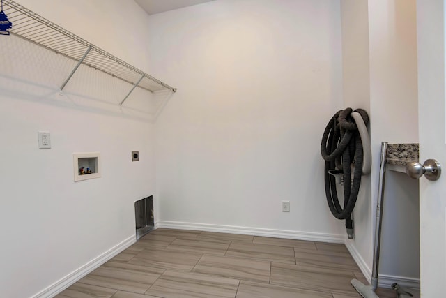 washroom featuring laundry area, hookup for a washing machine, hookup for an electric dryer, and baseboards