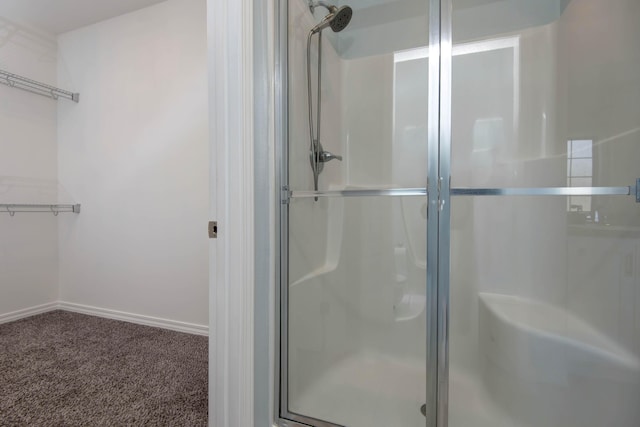 full bathroom with baseboards and a stall shower