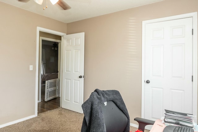 office area featuring baseboards, ceiling fan, and carpet flooring