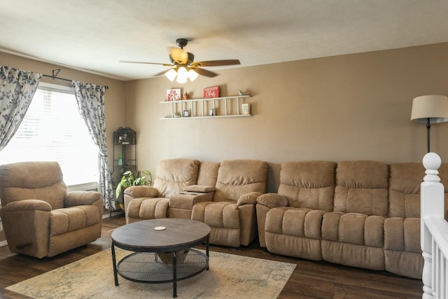 living area featuring dark wood finished floors and a ceiling fan