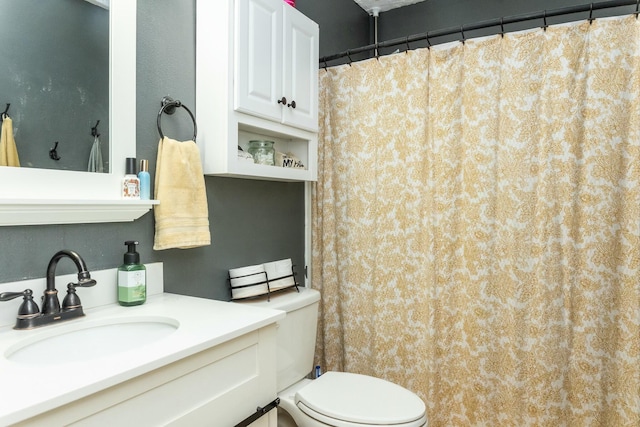 bathroom featuring toilet and vanity